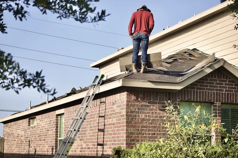 Professional roofer working on a residential roof in Penn Valley